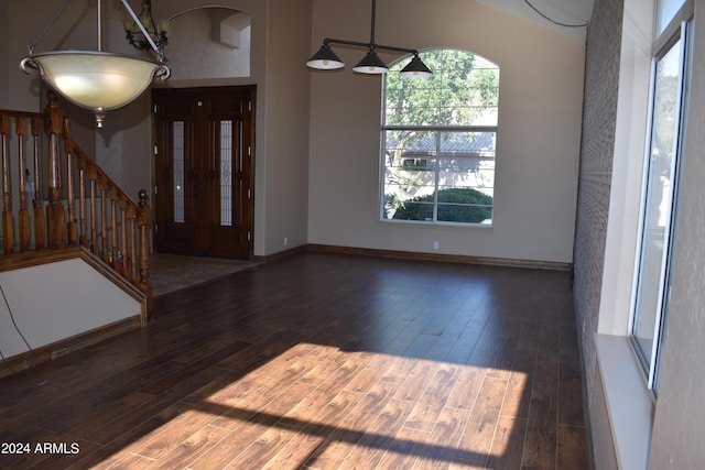 entrance foyer featuring baseboards, stairway, and wood finished floors