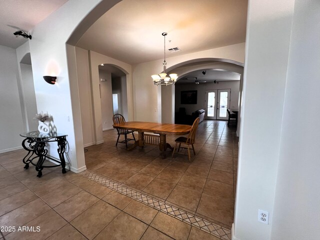 2427 W Desert Hills Estate Dr, Phoenix, AZ 85086 - dining area featuring tile patterned floors, french doors, arched walkways, and baseboards