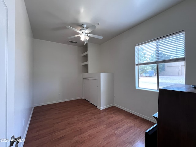 2427 W Desert Hills Estate Dr, Phoenix, AZ 85086 - unfurnished room featuring a ceiling fan, wood finished floors, and baseboards