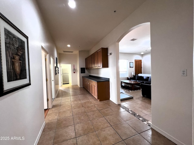 2427 W Desert Hills Estate Dr, Phoenix, AZ 85086 - corridor with recessed lighting, arched walkways, light tile patterned flooring, and baseboards