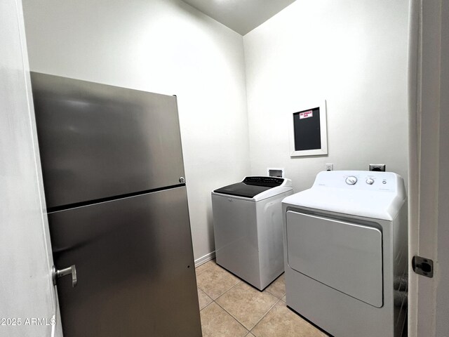 2427 W Desert Hills Estate Dr, Phoenix, AZ 85086 - clothes washing area featuring washer and clothes dryer and light tile patterned flooring