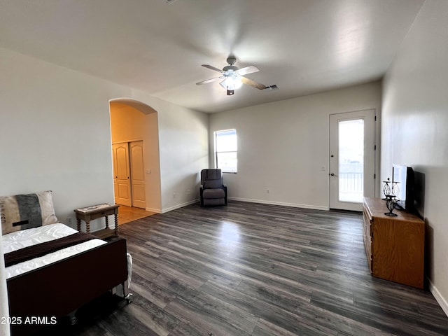 2427 W Desert Hills Estate Dr, Phoenix, AZ 85086 - bedroom featuring arched walkways, dark wood-type flooring, baseboards, and ceiling fan