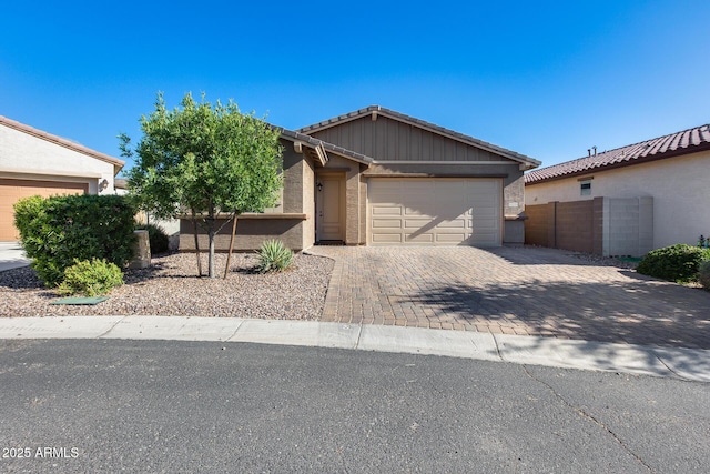 12211 W Hide Trl, Peoria, AZ 85383 - view of front facade with driveway, a garage, a tiled roof, and stucco siding