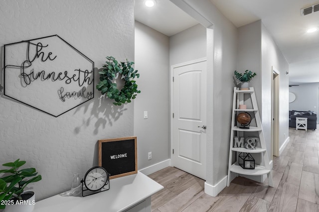 12211 W Hide Trl, Peoria, AZ 85383 - hallway with light wood-style floors and a textured wall