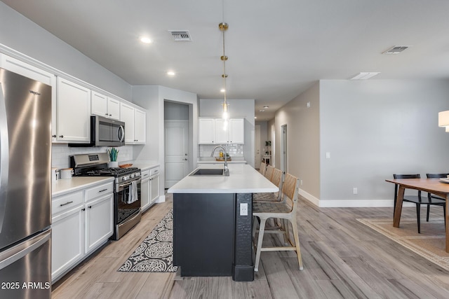 12211 W Hide Trl, Peoria, AZ 85383 - kitchen featuring appliances with stainless steel finishes, light wood-type flooring, backsplash, light countertops, and recessed lighting