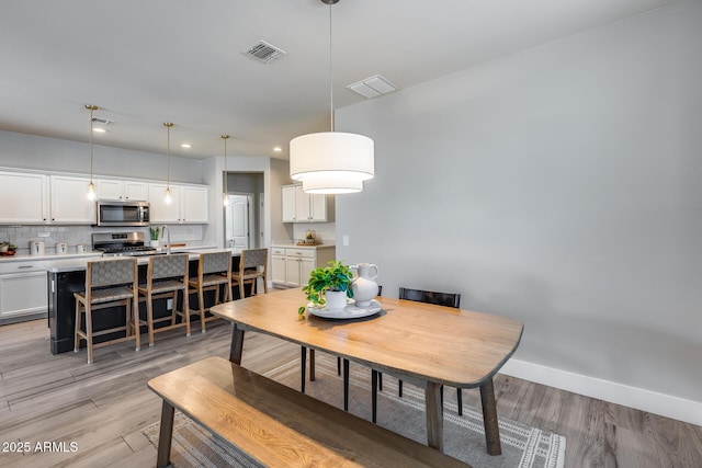 12211 W Hide Trl, Peoria, AZ 85383 - dining area with light wood-style floors and recessed lighting