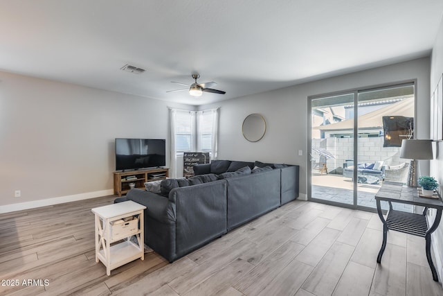 12211 W Hide Trl, Peoria, AZ 85383 - living area with light wood finished floors, ceiling fan, and healthy amount of natural light