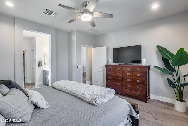 12211 W Hide Trl, Peoria, AZ 85383 - bedroom featuring light wood finished floors, recessed lighting, a ceiling fan, and connected bathroom