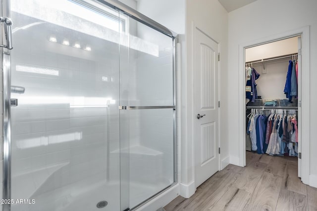 12211 W Hide Trl, Peoria, AZ 85383 - full bath featuring a stall shower, wood finished floors, and a walk in closet