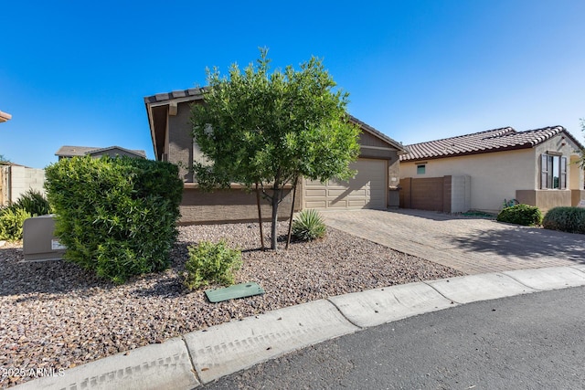 12211 W Hide Trl, Peoria, AZ 85383 - view of front of house with stucco siding, driveway, a garage, and a tile roof