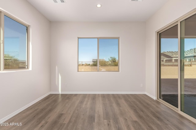 unfurnished room with wood-type flooring