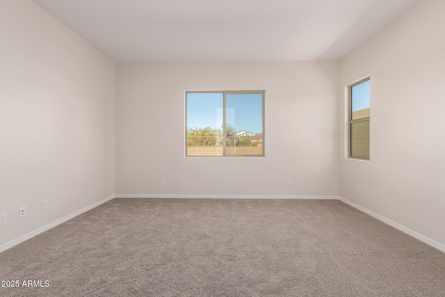 spare room with carpet and plenty of natural light