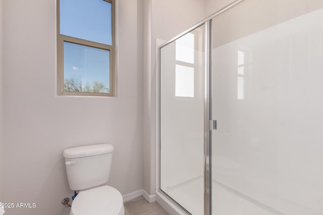 bathroom featuring toilet and walk in shower