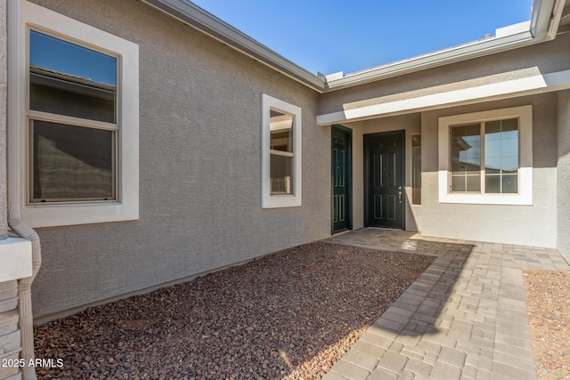 entrance to property featuring a patio area