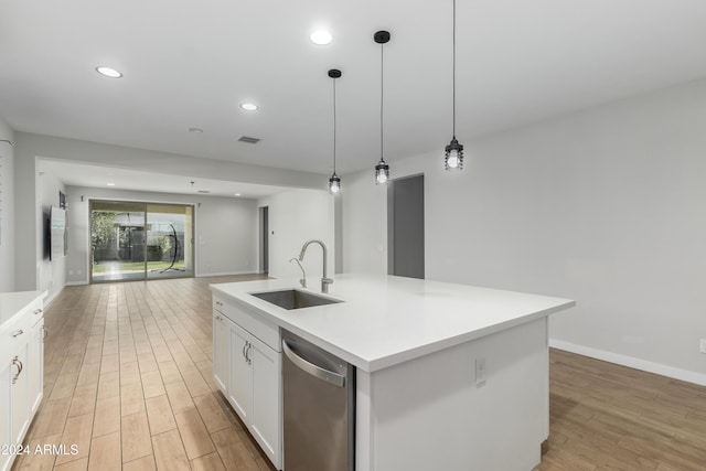 kitchen with sink, decorative light fixtures, a center island with sink, stainless steel dishwasher, and white cabinets