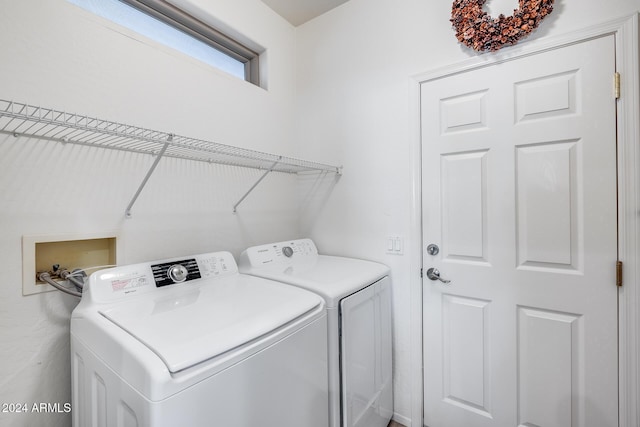 clothes washing area with separate washer and dryer