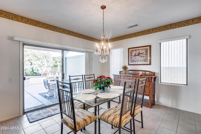 dining area featuring light tile patterned flooring and an inviting chandelier