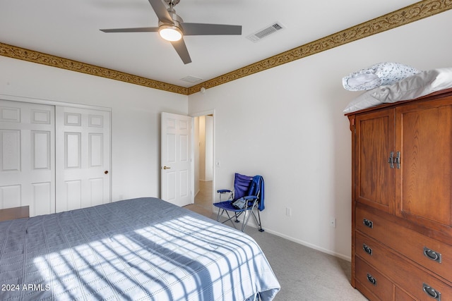 carpeted bedroom featuring ceiling fan and a closet