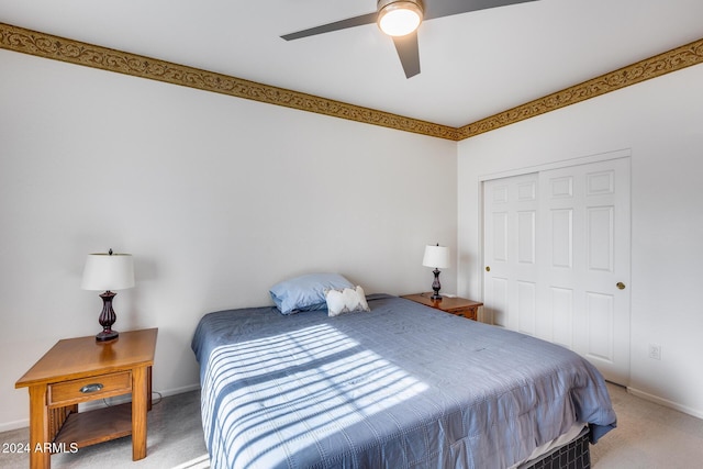 bedroom with carpet, ceiling fan, and a closet