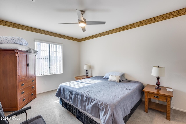 bedroom with ceiling fan and light colored carpet