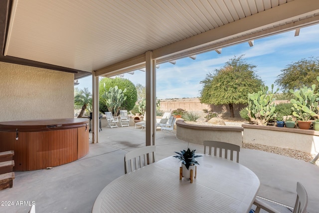 view of patio / terrace with a hot tub