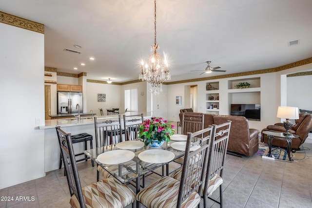 dining space with built in shelves, light tile patterned floors, and ceiling fan with notable chandelier