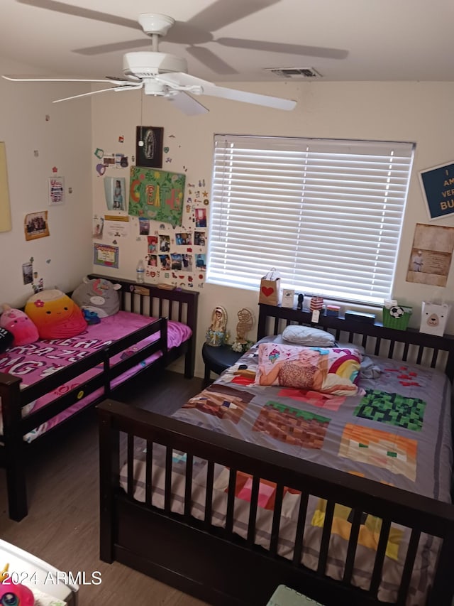 bedroom with ceiling fan and hardwood / wood-style floors