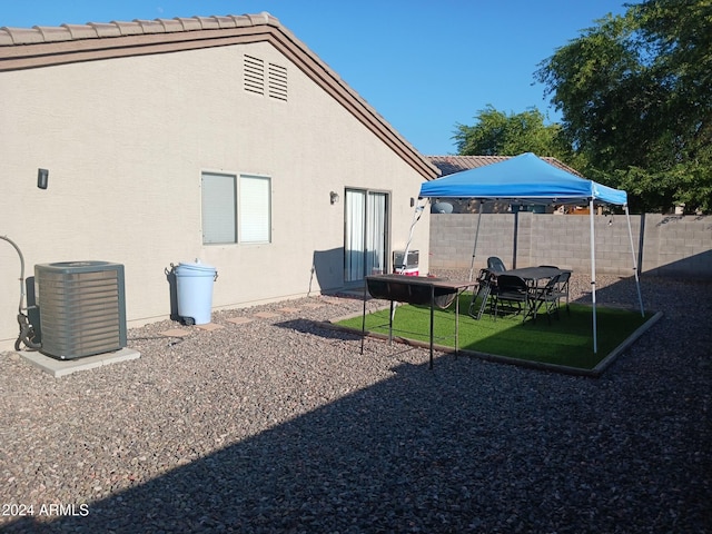 back of property with a patio and central AC unit