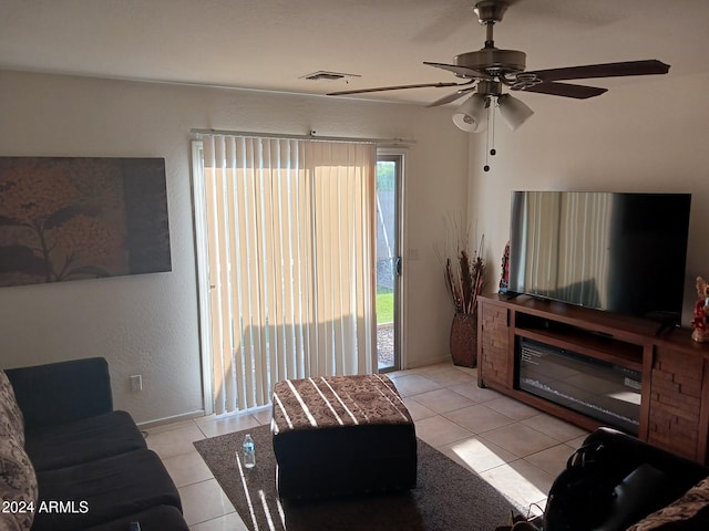 living room with ceiling fan and light tile patterned flooring