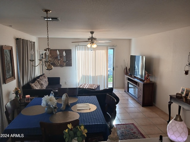 dining space featuring ceiling fan and light tile patterned floors