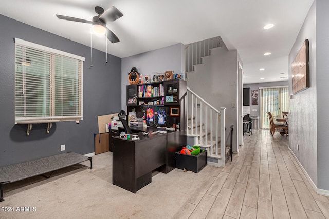 home office featuring ceiling fan and light hardwood / wood-style flooring