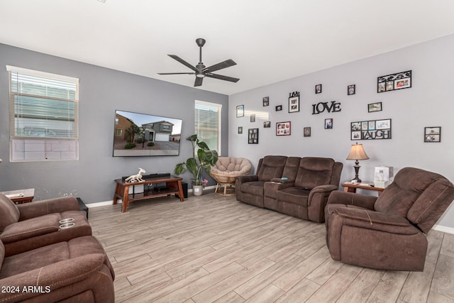 living room featuring ceiling fan and light wood-type flooring