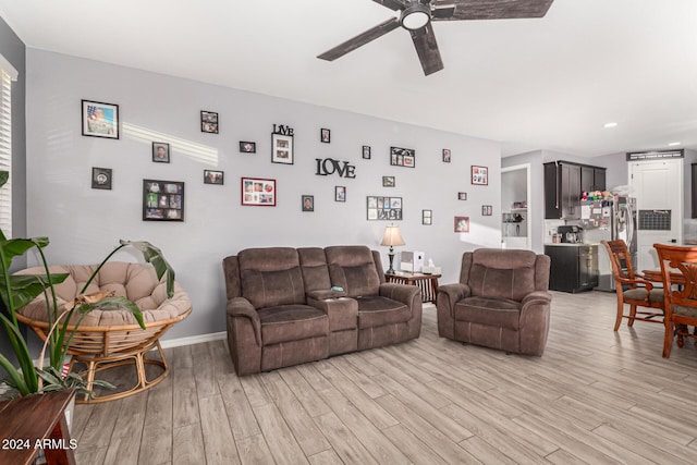 living room with hardwood / wood-style flooring and ceiling fan