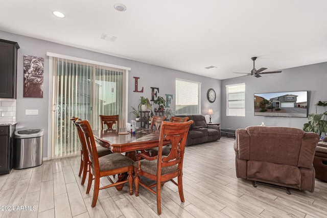 dining space with light hardwood / wood-style floors and ceiling fan