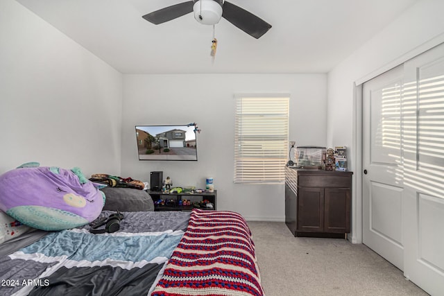 carpeted bedroom with multiple windows and ceiling fan