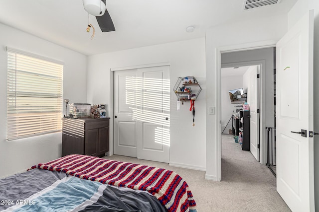 bedroom with ceiling fan and light colored carpet