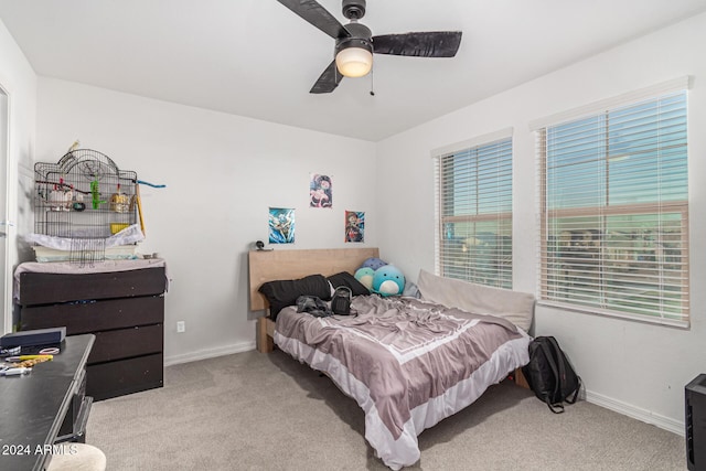 bedroom featuring ceiling fan and light carpet