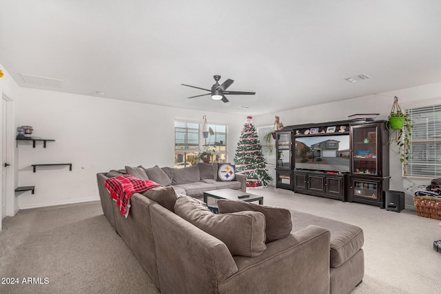 living room with light colored carpet and ceiling fan