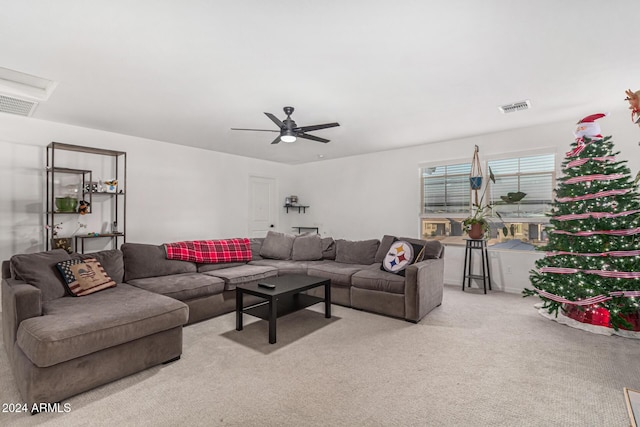 carpeted living room featuring ceiling fan