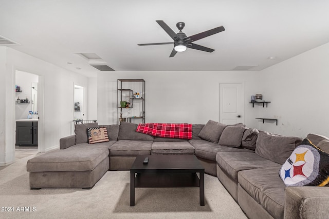 carpeted living room featuring ceiling fan