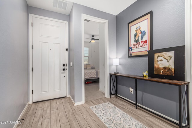 foyer entrance featuring ceiling fan and light hardwood / wood-style flooring