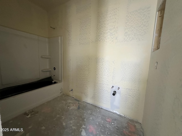 full bathroom featuring bathing tub / shower combination and concrete floors