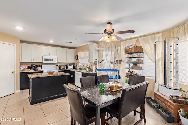 12426 W Surrey Ave, El Mirage, AZ 85335 - dining space with light tile patterned flooring, a ceiling fan, and visible vents