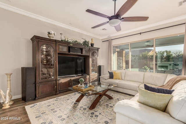 living room featuring ornamental molding, ceiling fan, and dark hardwood / wood-style flooring