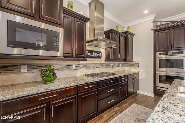 kitchen featuring wall chimney range hood, decorative backsplash, appliances with stainless steel finishes, dark hardwood / wood-style floors, and ornamental molding