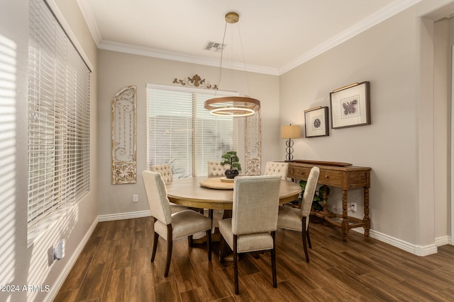 dining space with ornamental molding, an inviting chandelier, and dark hardwood / wood-style floors