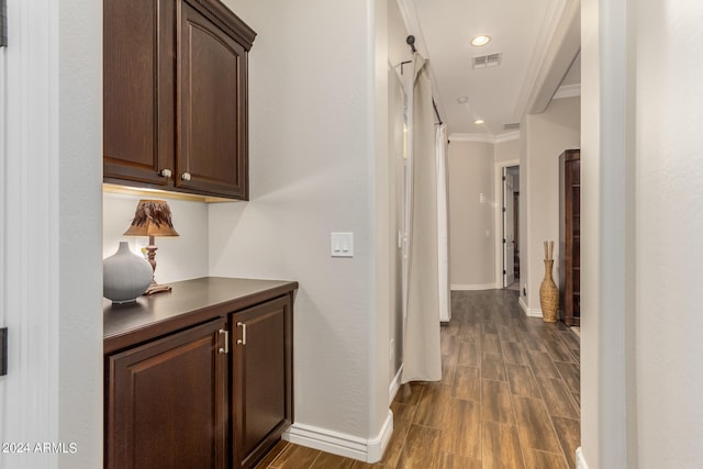 hallway with crown molding and dark hardwood / wood-style floors