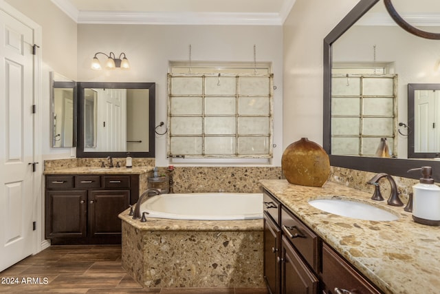 bathroom with vanity, crown molding, a relaxing tiled tub, and hardwood / wood-style flooring