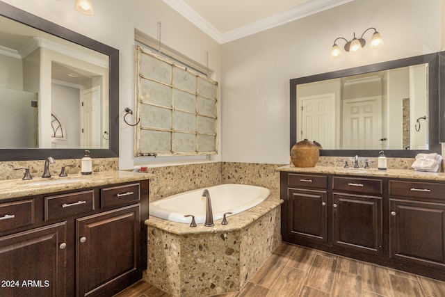 bathroom with vanity, ornamental molding, wood-type flooring, and tiled bath