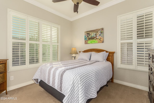 carpeted bedroom with ornamental molding and ceiling fan